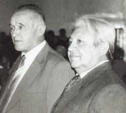 Two men at a gathering, neither identified here